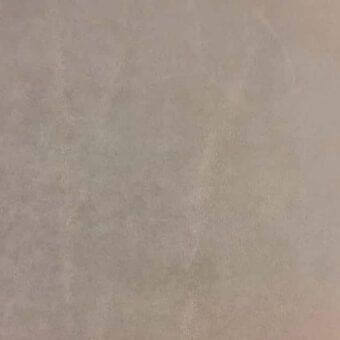 Rugiano Oasi rug, beige cashmere and leather blend, textured mottled surface, uniform solid color, indoor use, diffused lighting.